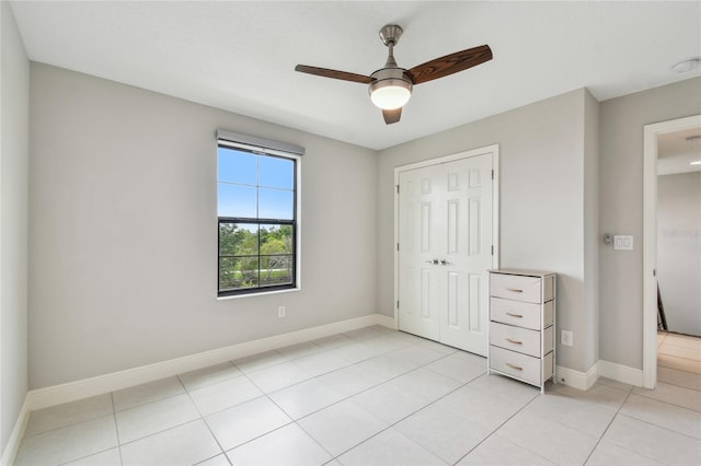 13311 Dorado Shores Ave, Riverview, FL 33579 - unfurnished bedroom featuring a closet, baseboards, light tile patterned floors, and ceiling fan
