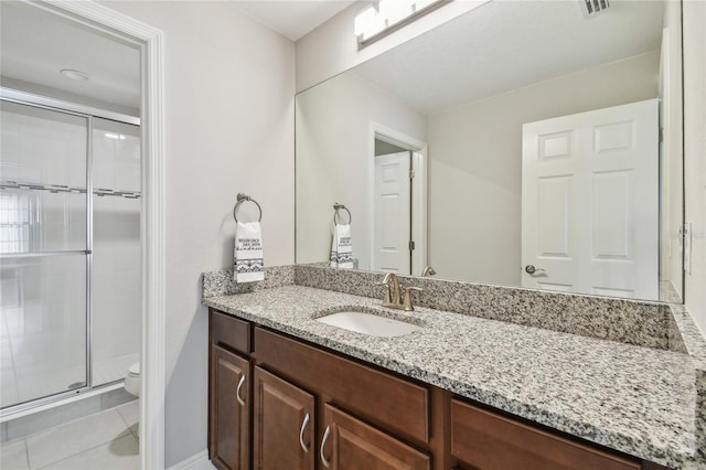 13311 Dorado Shores Ave, Riverview, FL 33579 - bathroom with vanity, toilet, a shower stall, and tile patterned flooring