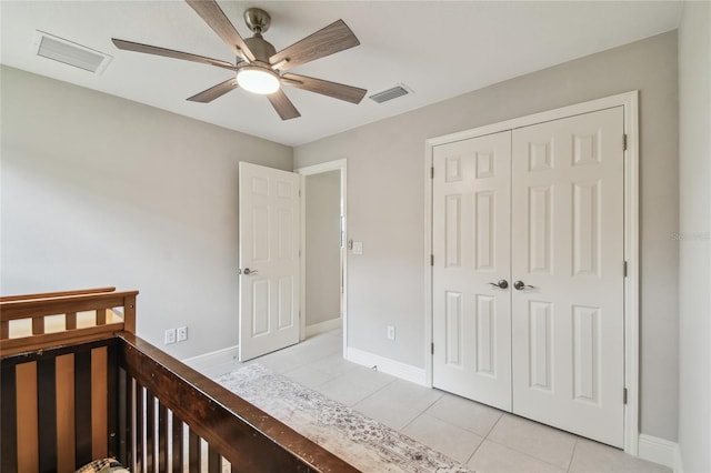 13311 Dorado Shores Ave, Riverview, FL 33579 - bedroom with light tile patterned flooring, baseboards, a closet, and a ceiling fan