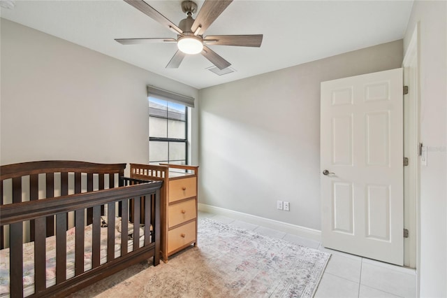 13311 Dorado Shores Ave, Riverview, FL 33579 - unfurnished bedroom with light tile patterned floors, a crib, baseboards, and a ceiling fan