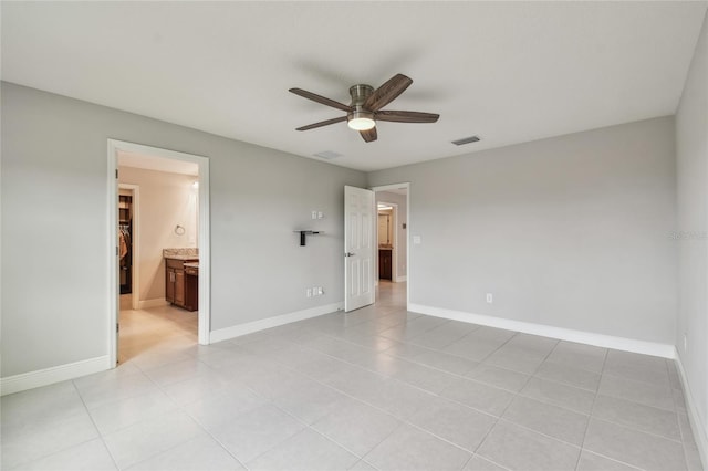 13311 Dorado Shores Ave, Riverview, FL 33579 - unfurnished bedroom with baseboards, light tile patterned floors, a ceiling fan, and connected bathroom