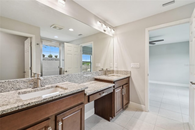 13311 Dorado Shores Ave, Riverview, FL 33579 - full bath with double vanity, tile patterned flooring, baseboards, a stall shower, and a ceiling fan