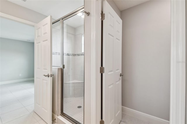 13311 Dorado Shores Ave, Riverview, FL 33579 - bathroom featuring a shower stall, baseboards, and tile patterned floors