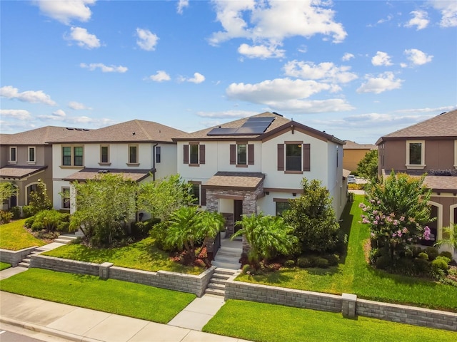 13311 Dorado Shores Ave, Riverview, FL 33579 - view of front of property featuring stucco siding, roof mounted solar panels, a front yard, and a residential view