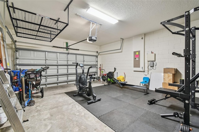 13311 Dorado Shores Ave, Riverview, FL 33579 - workout room with a garage, a textured ceiling, concrete block wall, and electric panel