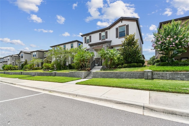 13311 Dorado Shores Ave, Riverview, FL 33579 - view of front of house with a residential view, stucco siding, stone siding, and a front lawn