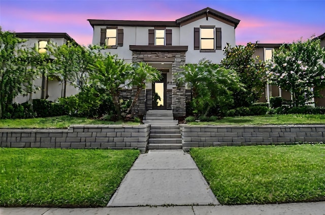 13311 Dorado Shores Ave, Riverview, FL 33579 - contemporary house with stucco siding, stone siding, and a lawn