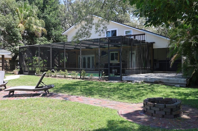 12929 Sugar Creek Blvd, Hudson, FL 34669 - rear view of property featuring an outdoor fire pit, an outdoor pool, a yard, glass enclosure, and a patio area