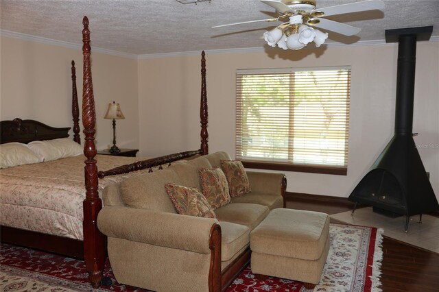 12929 Sugar Creek Blvd, Hudson, FL 34669 - bedroom featuring a wood stove, wood finished floors, crown molding, a textured ceiling, and a ceiling fan