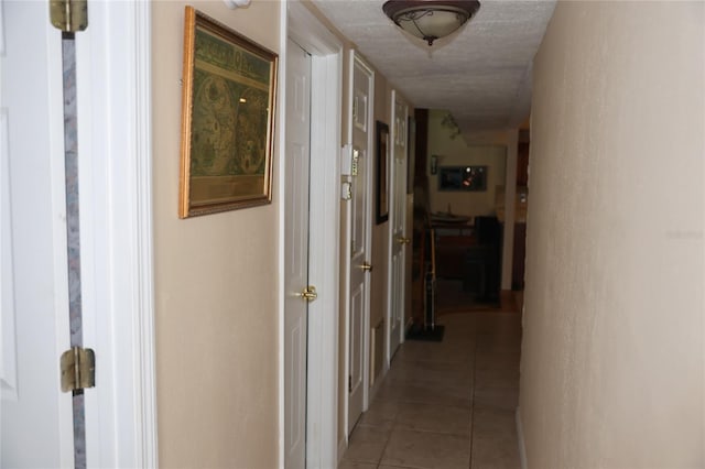 12929 Sugar Creek Blvd, Hudson, FL 34669 - corridor featuring light tile patterned floors and a textured ceiling