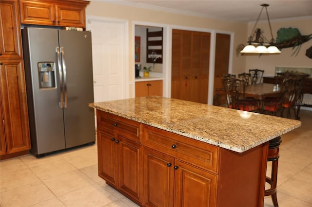 12929 Sugar Creek Blvd, Hudson, FL 34669 - kitchen with stainless steel fridge, light stone counters, light tile patterned flooring, and pendant lighting
