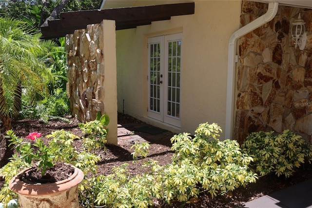 12929 Sugar Creek Blvd, Hudson, FL 34669 - exterior view of french doors, stone siding, and stucco siding