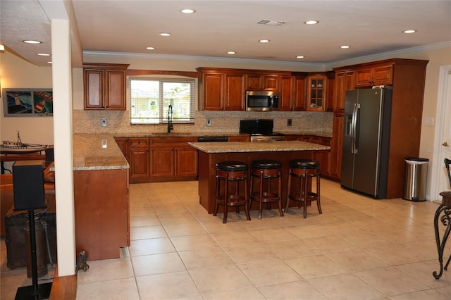 12929 Sugar Creek Blvd, Hudson, FL 34669 - kitchen with appliances with stainless steel finishes, a sink, ornamental molding, a kitchen breakfast bar, and backsplash