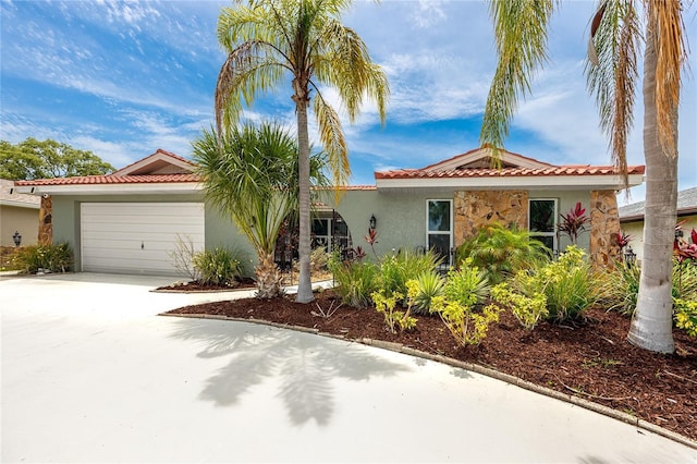9909 San Mateo Way, Port Richey, FL 34668 - view of front of property with stucco siding, a tiled roof, and a garage
