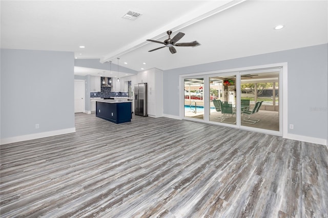 9909 San Mateo Way, Port Richey, FL 34668 - unfurnished living room featuring wood finished floors, ceiling fan, baseboards, and recessed lighting