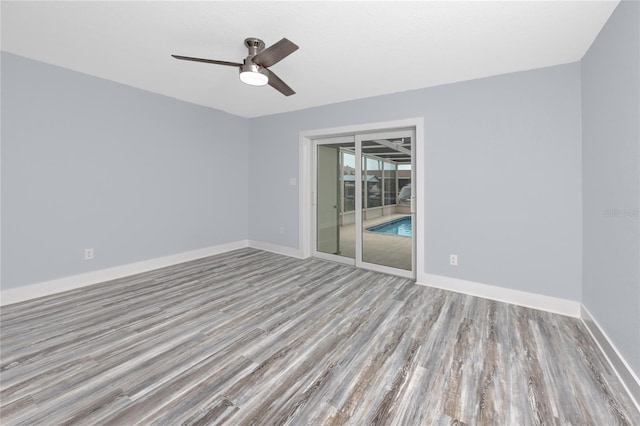 9909 San Mateo Way, Port Richey, FL 34668 - spare room with wood finished floors, ceiling fan, and baseboards