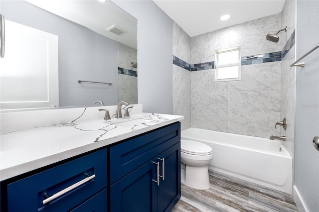 9909 San Mateo Way, Port Richey, FL 34668 - bathroom featuring vanity, toilet, wood finished floors, bathing tub / shower combination, and recessed lighting