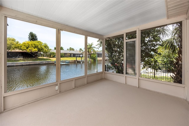 9909 San Mateo Way, Port Richey, FL 34668 - unfurnished sunroom featuring a water view