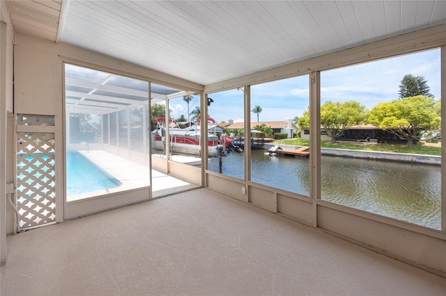9909 San Mateo Way, Port Richey, FL 34668 - unfurnished sunroom featuring a water view
