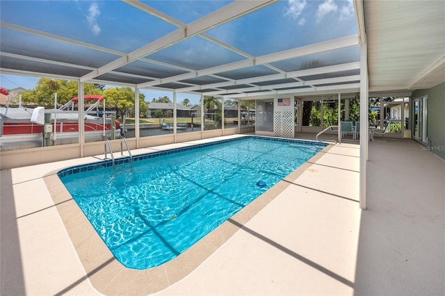 9909 San Mateo Way, Port Richey, FL 34668 - outdoor pool with a patio and glass enclosure