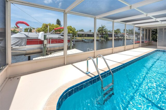 9909 San Mateo Way, Port Richey, FL 34668 - outdoor pool featuring a water view, boat lift, and a boat dock