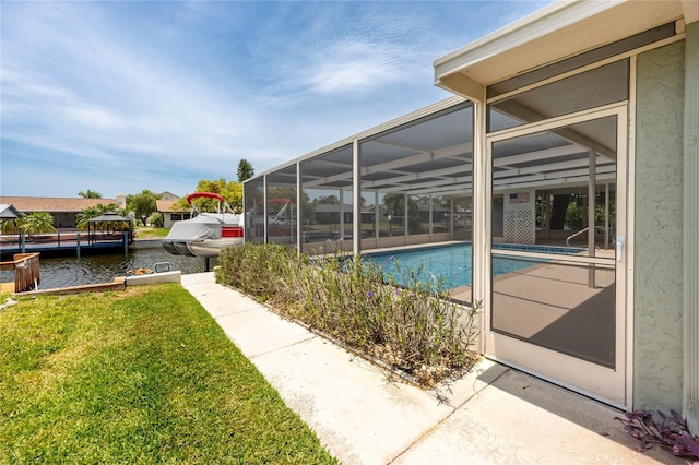 9909 San Mateo Way, Port Richey, FL 34668 - outdoor pool featuring a yard, a water view, and glass enclosure