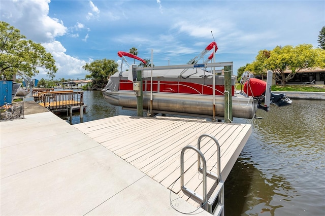 9909 San Mateo Way, Port Richey, FL 34668 - dock with boat lift and a water view