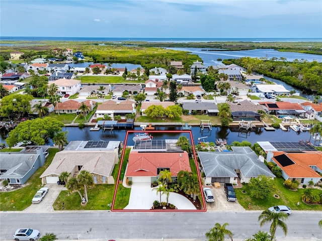 9909 San Mateo Way, Port Richey, FL 34668 - aerial view of residential area featuring a large body of water and property boundaries highlighted