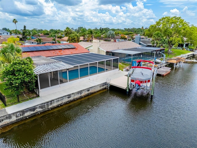 9909 San Mateo Way, Port Richey, FL 34668 - dock area with boat lift, a water view, glass enclosure, and an outdoor pool