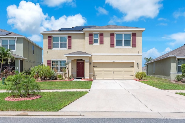 14135 Arbor Pines Dr, Riverview, FL 33579 - traditional-style home with stucco siding, a garage, concrete driveway, solar panels, and a front lawn
