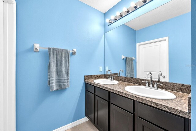 14135 Arbor Pines Dr, Riverview, FL 33579 - bathroom with double vanity, baseboards, and tile patterned floors