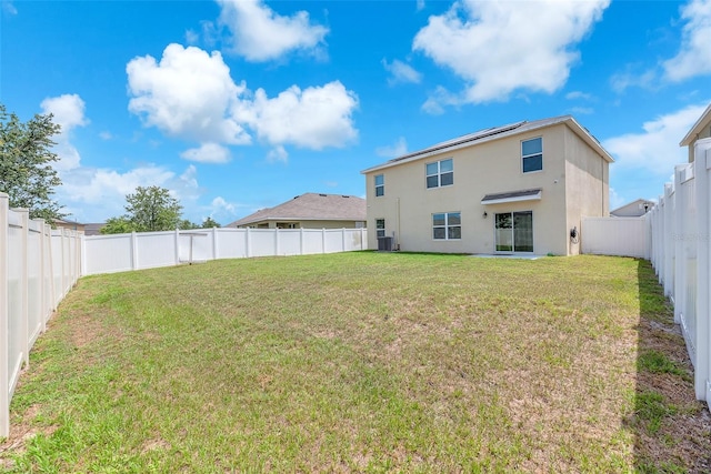 14135 Arbor Pines Dr, Riverview, FL 33579 - rear view of house featuring stucco siding, central AC unit, and roof mounted solar panels