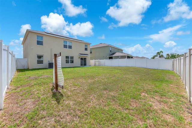14135 Arbor Pines Dr, Riverview, FL 33579 - rear view of house with stucco siding, central air condition unit, and solar panels