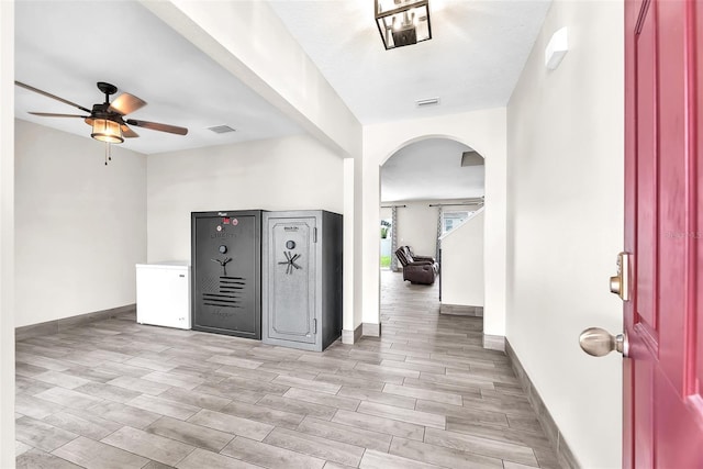 14135 Arbor Pines Dr, Riverview, FL 33579 - entryway with arched walkways, ceiling fan, and light wood-type flooring