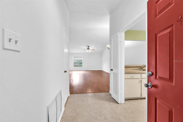 11816 Cedarfield Dr, Riverview, FL 33579 - corridor featuring light tile patterned floors and a sink