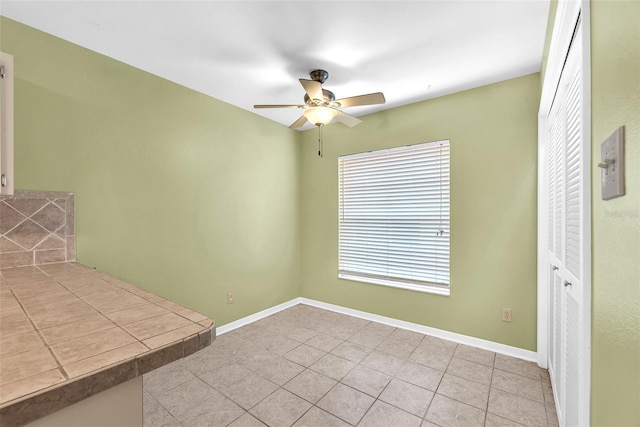 11816 Cedarfield Dr, Riverview, FL 33579 - unfurnished dining area featuring ceiling fan, tile patterned floors, and baseboards