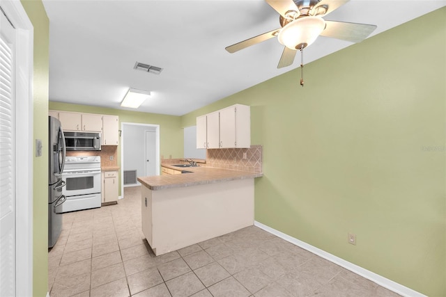 11816 Cedarfield Dr, Riverview, FL 33579 - kitchen with stainless steel appliances, a peninsula, tasteful backsplash, a sink, and light tile patterned floors