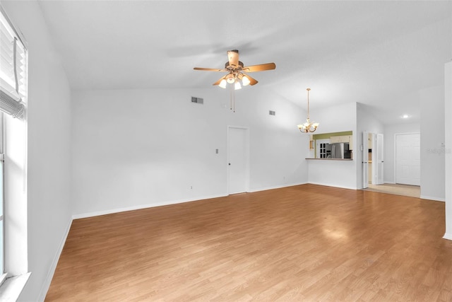 11816 Cedarfield Dr, Riverview, FL 33579 - unfurnished living room featuring a chandelier, ceiling fan, lofted ceiling, light wood-type flooring, and baseboards