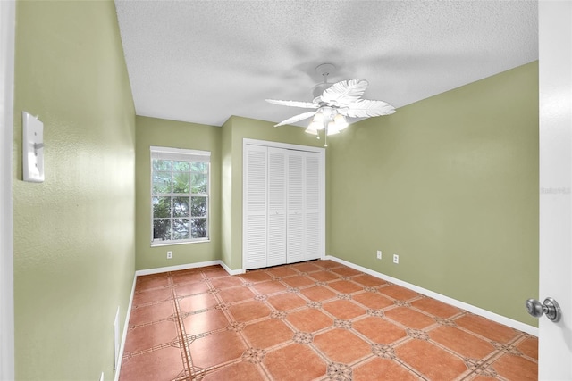 11816 Cedarfield Dr, Riverview, FL 33579 - unfurnished bedroom with a closet, baseboards, a textured ceiling, and a ceiling fan