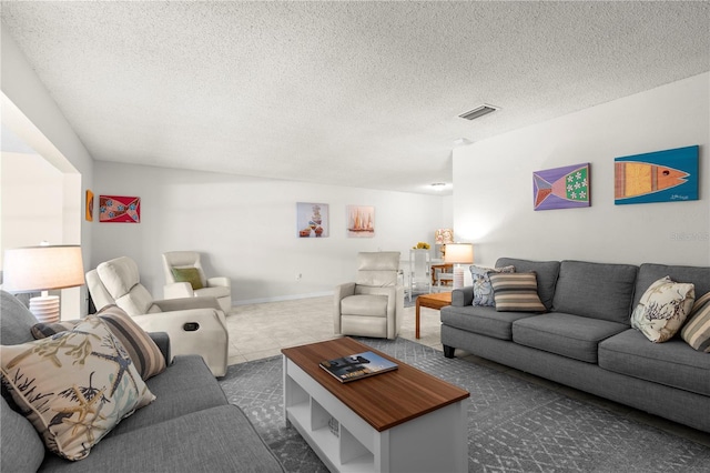3114 59th St S Unit 203, Gulfport, FL 33707 - living area with a textured ceiling and tile patterned floors