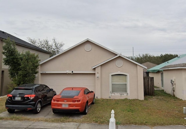 11334 Ivy Flower Loop, Riverview, FL 33578 - view of front facade featuring stucco siding, an attached garage, driveway, and a front yard