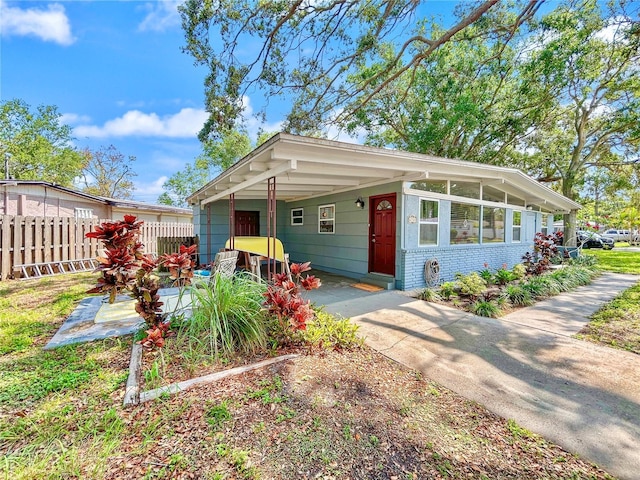 6700 14th St N, Saint Petersburg, FL 33702 - view of front of house featuring driveway, a carport, and brick siding