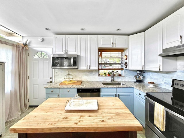 6700 14th St N, Saint Petersburg, FL 33702 - kitchen featuring stainless steel appliances, a sink, under cabinet range hood, and white cabinets