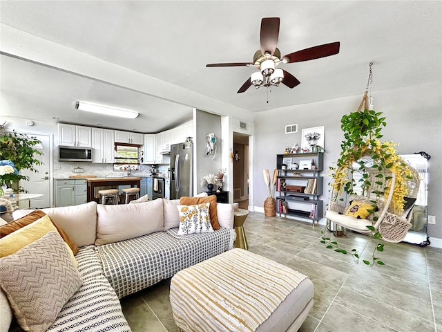 6700 14th St N, Saint Petersburg, FL 33702 - living area featuring a ceiling fan, baseboards, and light tile patterned flooring