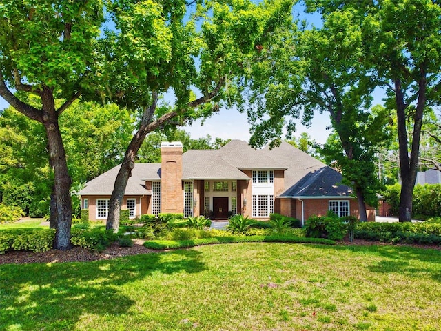 16502 Millan De Avila, Tampa, FL 33613 - view of front of house featuring a chimney and a front yard