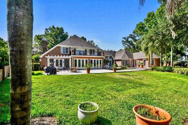 16502 Millan De Avila, Tampa, FL 33613 - back of property featuring french doors, a patio, a yard, and a chimney