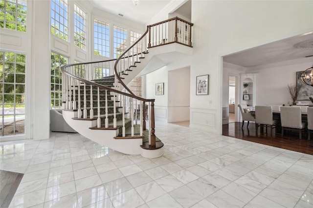 16502 Millan De Avila, Tampa, FL 33613 - stairs with a high ceiling, crown molding, plenty of natural light, a decorative wall, and a chandelier