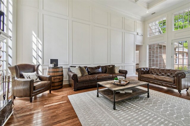 16502 Millan De Avila, Tampa, FL 33613 - living area with a decorative wall, a towering ceiling, crown molding, and wood finished floors