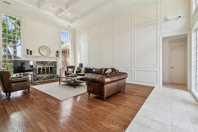 16502 Millan De Avila, Tampa, FL 33613 - living room featuring a decorative wall, crown molding, beamed ceiling, a fireplace, and coffered ceiling