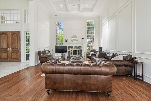16502 Millan De Avila, Tampa, FL 33613 - living room with a decorative wall, crown molding, a fireplace, dark wood-type flooring, and beam ceiling